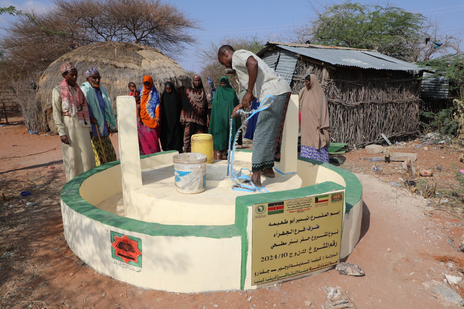 Close-up of hands holding a tin of rice, dressed in traditional attire, symbolizing charity or offering.